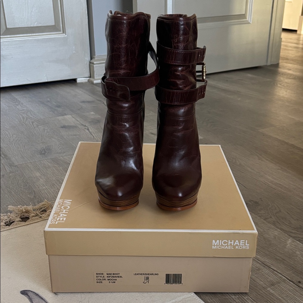 Michael Kors brown leather Mae platform ankle boots with gold buckles.